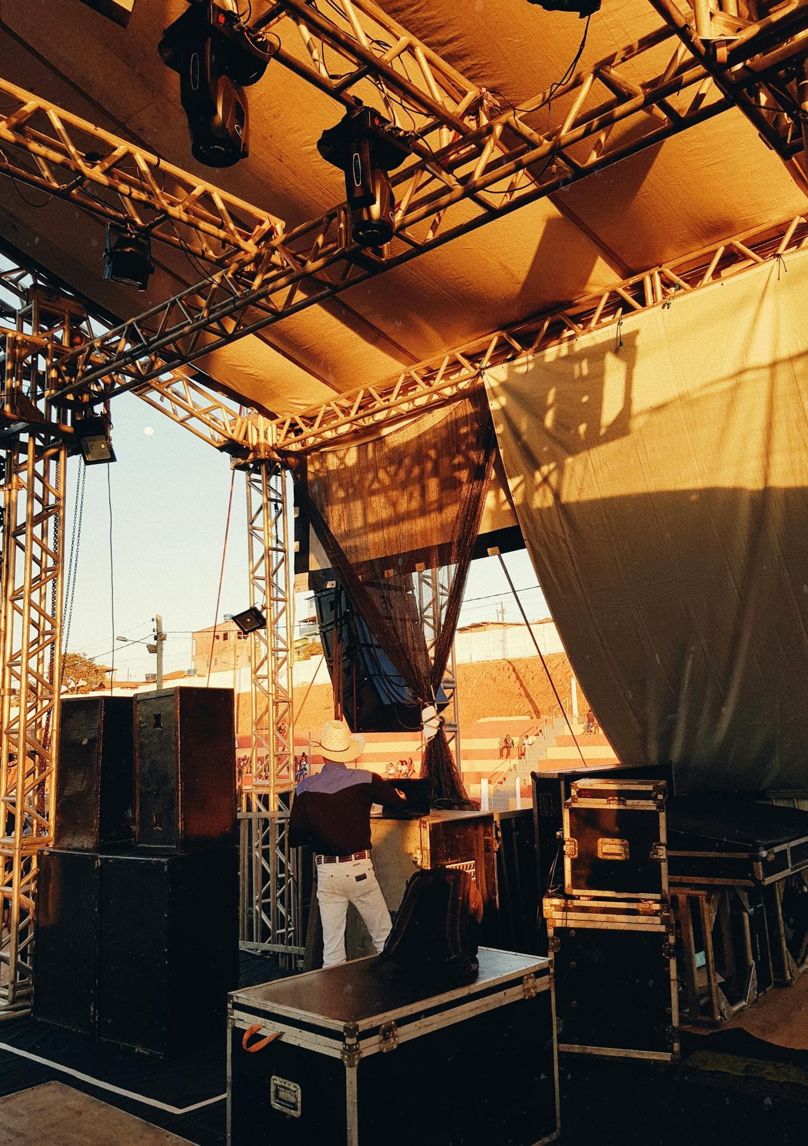 Flight cases and audiovisual equipment backstage at an event